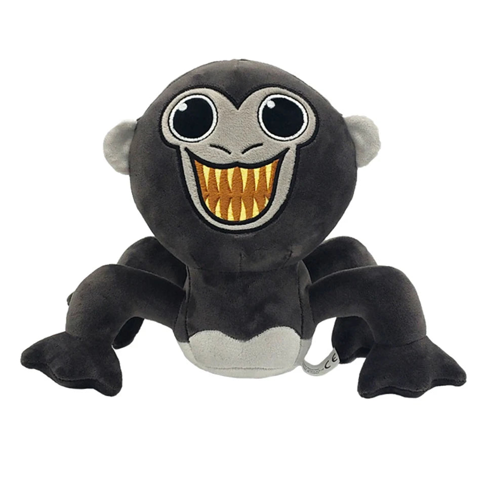 A plush toy of a monkey with large eyes and a wide, toothy grin.