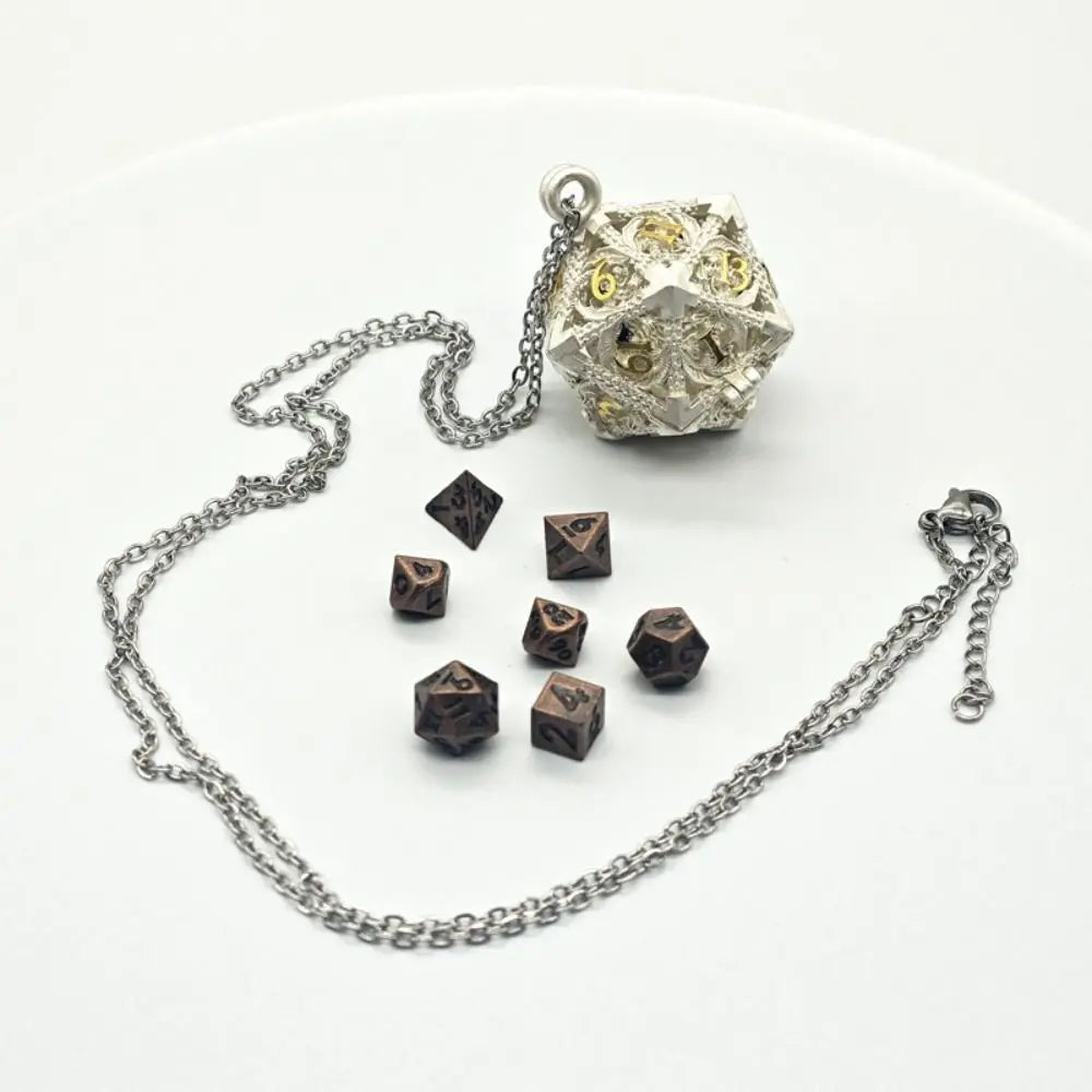 A silver metal polyhedral dice set with a pendant storage case resting on a white background.