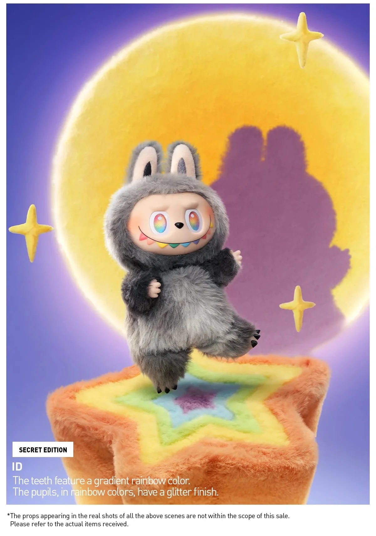 A gray Labubu vinyl plush pendant with colorful teeth and large eyes is displayed against a yellow moon background.