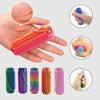 Various colors of spiky sensory keychains and a hand holding one for scale.