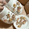 A pair of white shoe charms shaped like capybaras with glow-in-the-dark features are displayed on a shoe.