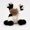 A soft, cuddly cow plush toy with black and white fur and brown accents.