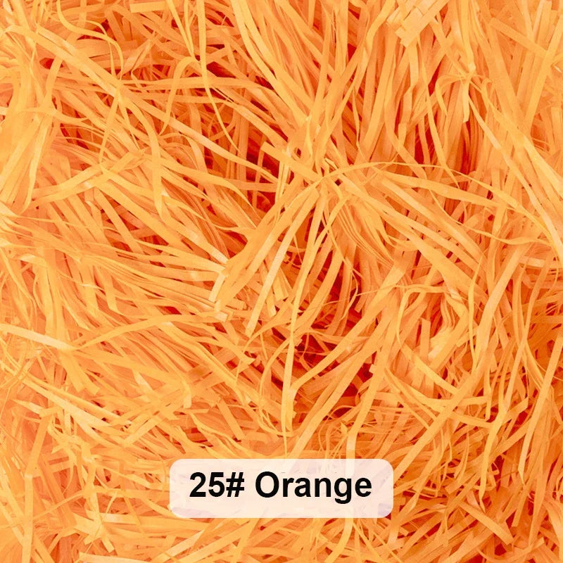 Orange raffia paper shreds used for gift boxes and baskets.