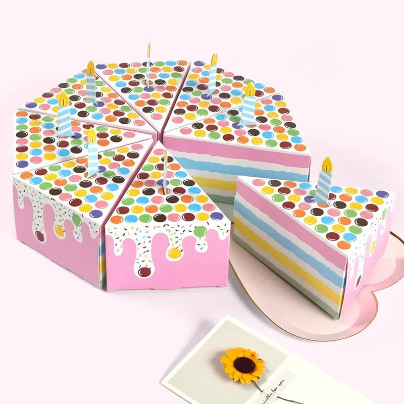 A display of colorful paper gift boxes shaped like candles with dot patterns for party favors