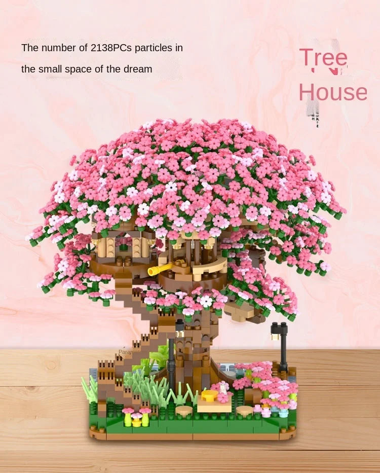 A detailed LEGO set of a pink cherry blossom tree in a house landscape with small flowers and lighting.