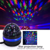 A star projection lamp emitting colorful light patterns and a crescent moon onto a dark background.