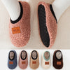 A collection of cozy plush baby slippers in various colors including gray, pink, beige, and brown.