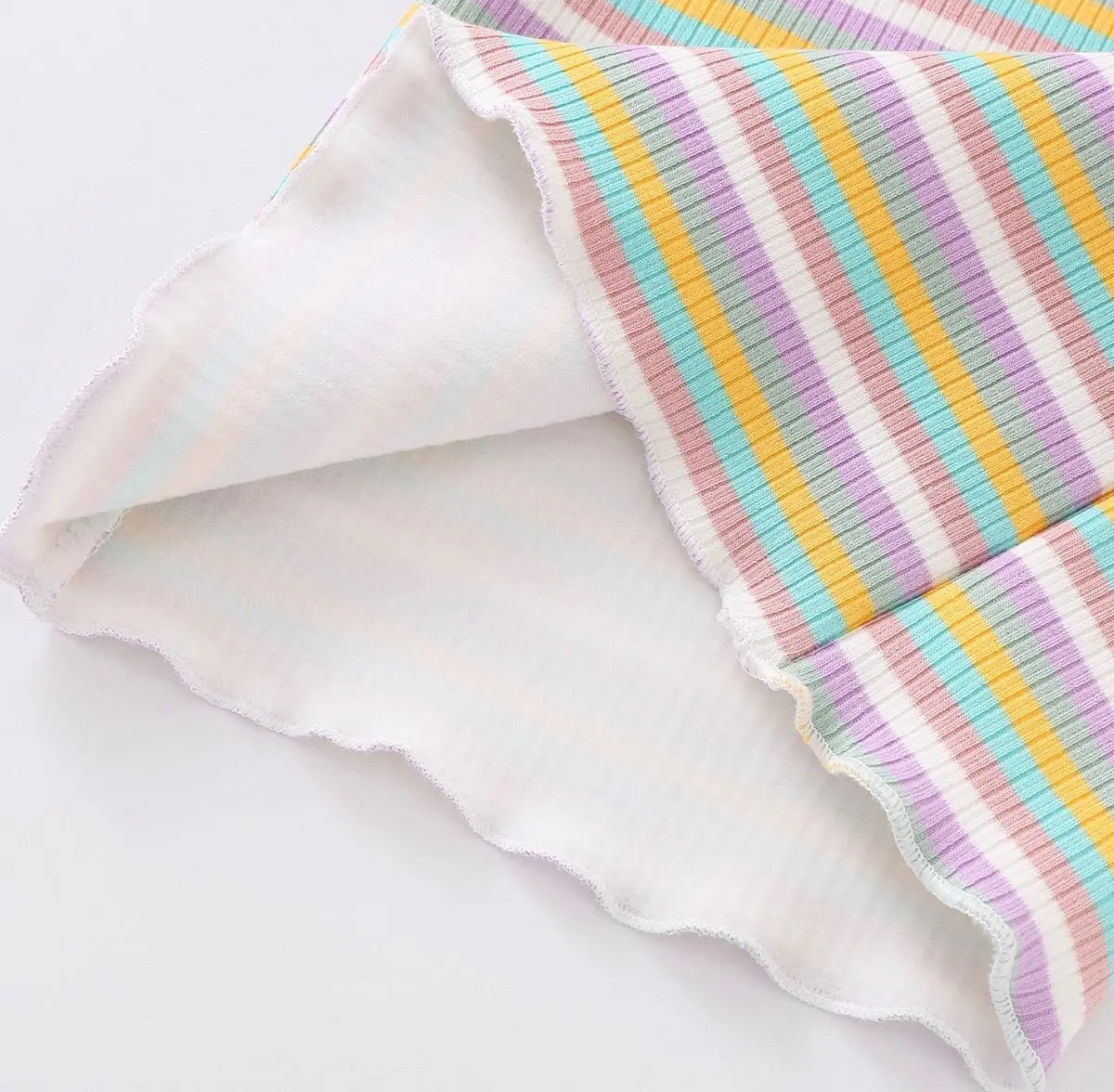 A close-up of a girls striped cotton t-shirt featuring pastel stripes in yellow, pink, and blue.