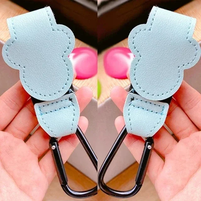 Light blue stroller organizer hooks with PU leather material shown being held by a hand