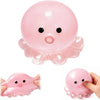 A pink octopus squishy stress ball with small eyes and tentacles shown from above and a hand holding it below.