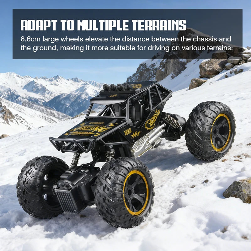 A black off-road RC car with large wheels is driving through snowy, mountainous terrain.
