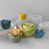 A collection of silicone molds shaped like roses in various pastel colors including yellow, green, blue, and white.