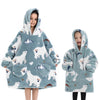 A young girl models a light blue and white fluffy hoodie sweater with a hood and pockets.
