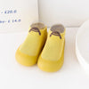 Pair of yellow knitted soft sole socks for babies and toddlers with a small animal design
