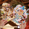 A hand holds a colorful 3D stereoscopic scene presentation sticker featuring a whimsical castle and magical elements.