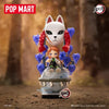 A collectible blind box figure of a white cat-like character with red hair and blue accents, displayed in a forest setting.