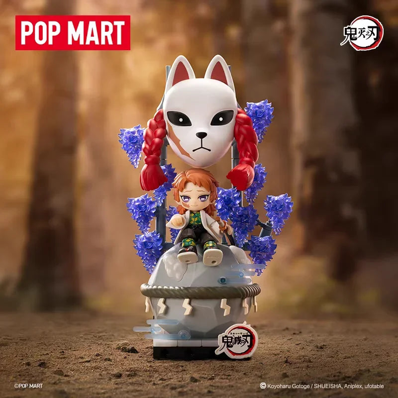A collectible blind box figure of a white cat-like character with red hair and blue accents, displayed in a forest setting.