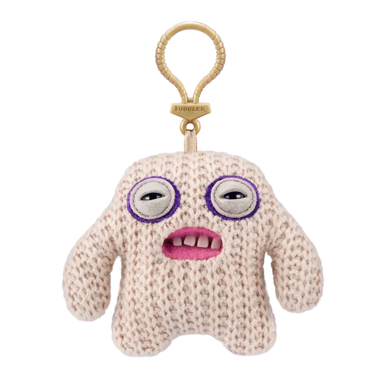 A light pink, fuzzy plush monster keychain with large purple eyes and a pink mouth, attached to a gold-colored loop.