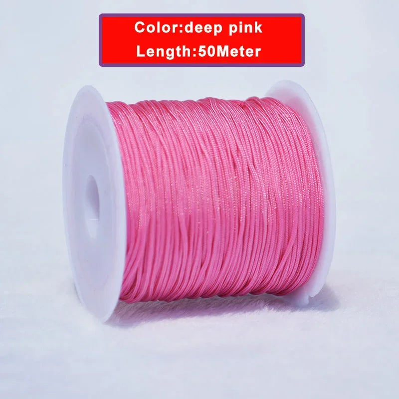 A spool of deep pink nylon knotting cord for jewelry making, 50 meters long.