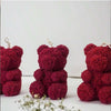 A close-up of a deep red 3D rose bear silicone mold for candle making.
