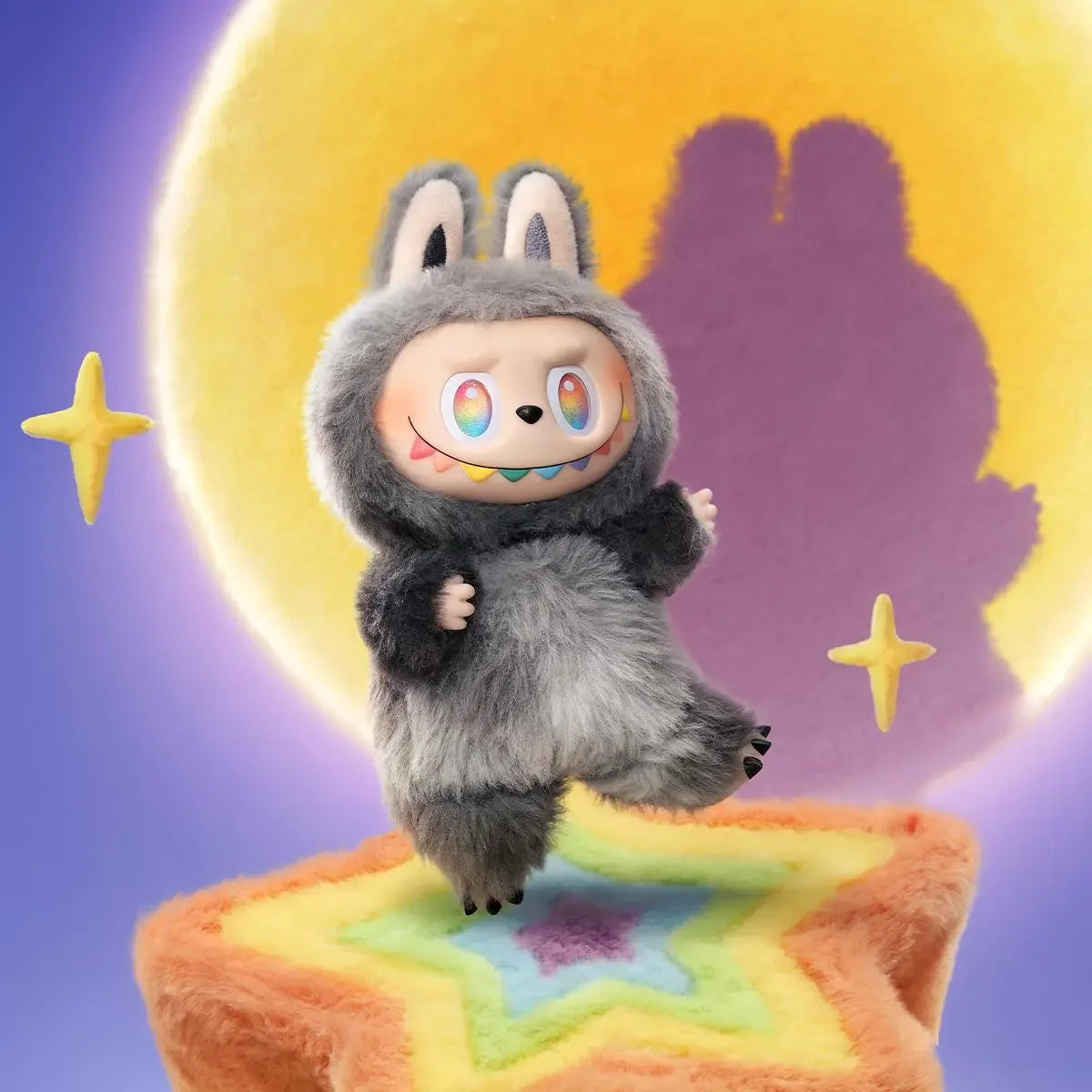 A gray Labubu vinyl plush pendant blind box sitting on an orange star-shaped surface with a purple background.