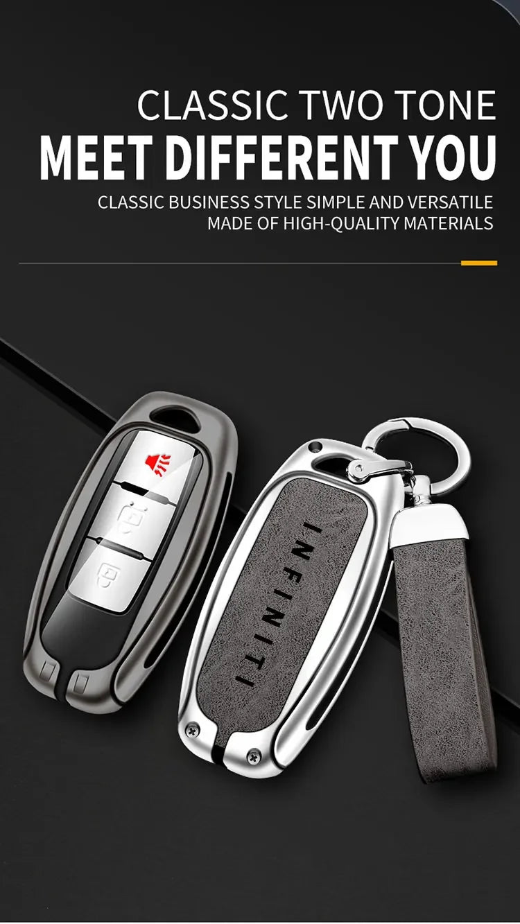 A silver key case cover for an Infiniti model, featuring a two-tone design and attached to a black strap.