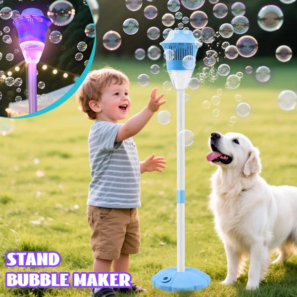 A toddler is playing with a stand bubble maker outdoors while a dog watches in a grassy field.