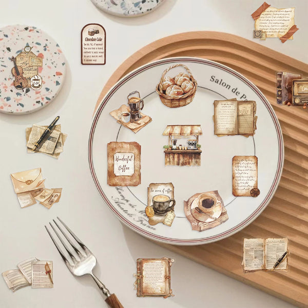 A wooden plate features various vintage and rustic elements like baked goods, old books, and writing tools.