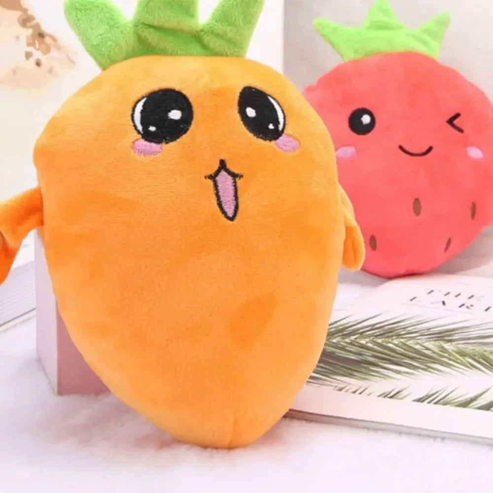 An orange musical fruit plush toy with a smiling face next to a red strawberry plush toy.