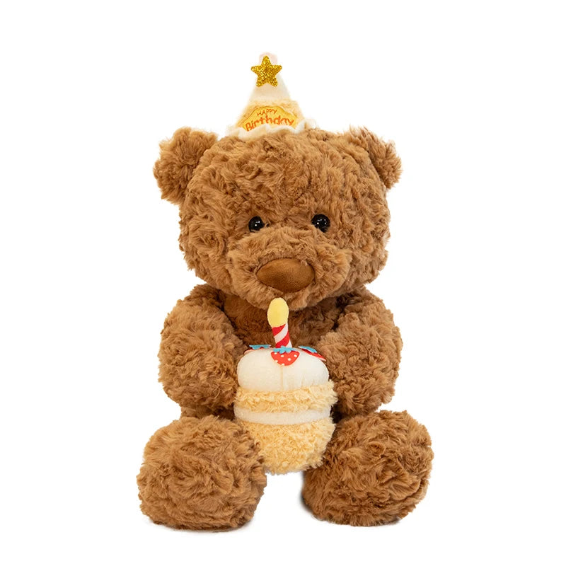 A brown teddy bear plush toy wearing a gold star hat and holding a birthday cake.