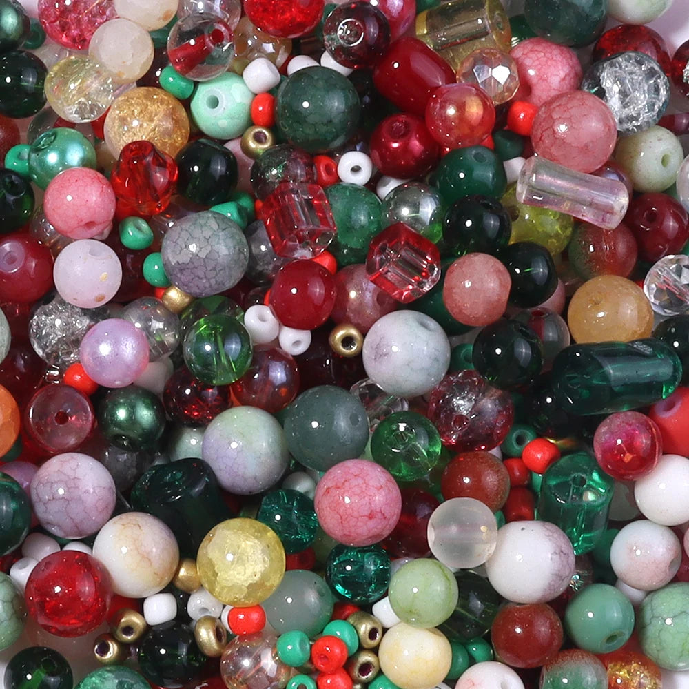 A close-up view of a vibrant mix of colorful glass beads including reds, greens, pinks, and clear stones for jewelry making