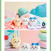 A collection of Chiikawa Usagi plush keychains and charms in various colors displayed on a pink background.