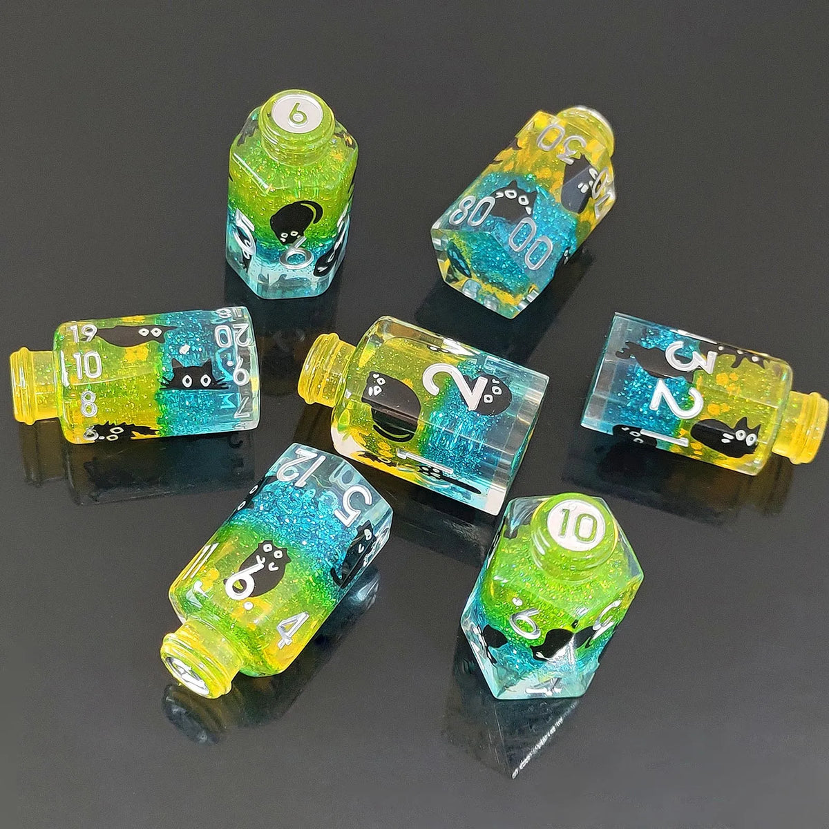 A collection of seven floral resin potion bottle polyhedral dice set in various shades of green and yellow.