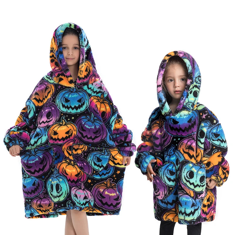 A young girl wearing a colorful Halloween-themed flannel hoodie sweater with pumpkin and spooky designs.