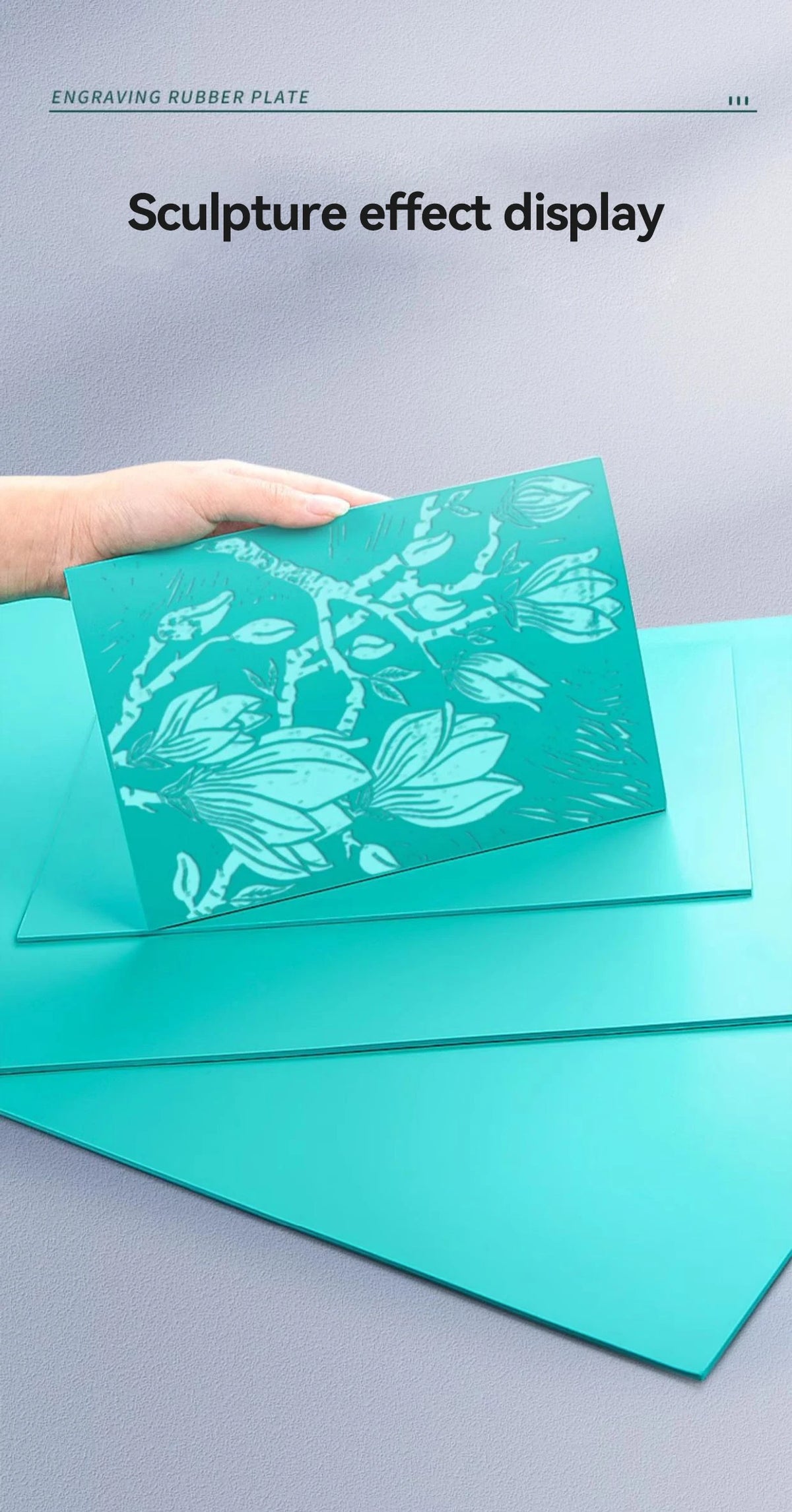 A hand displays a teal rubber plate with an engraved silhouette of leaves and branches, showing a sculpture effect display.