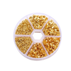 A circular display of gold jewelry making components including lobster clasps, jump rings, and crimps.
