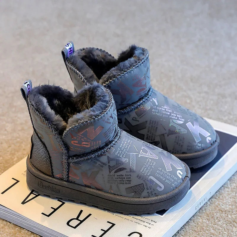 A pair of gray winter snow boots with faux fur lining and a non-slip sole resting on a white surface.