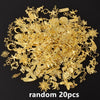 A pile of random gold metal charms and findings for DIY jewelry making