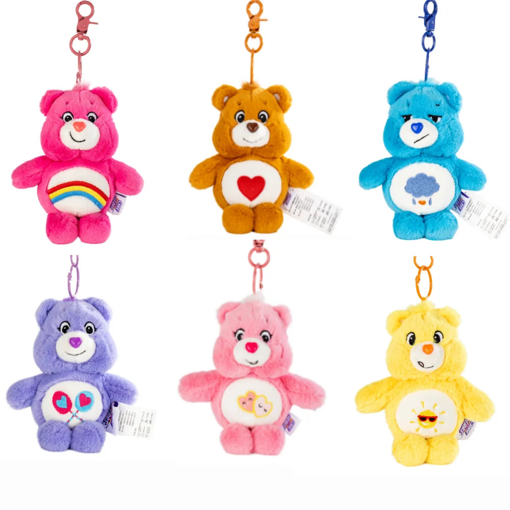 A collection of five colorful Care Bears plush keychains hanging from rings.