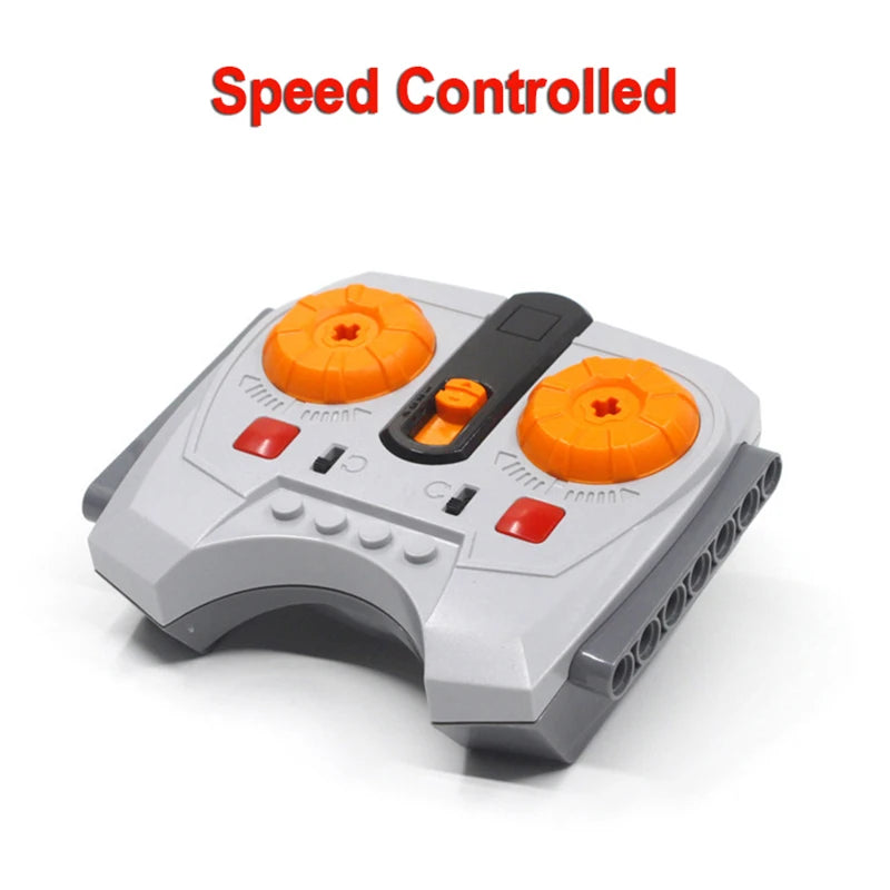 A gray technical power functions motor set for building blocks with orange components and a speed controlled label.