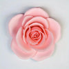 A soft pink floral silicone mold shaped like a rose, used for crafting candles, soap, and clay.
