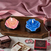A dark wooden tray holds blue and pink floral silicone candle molds, along with jewelry and gift boxes.