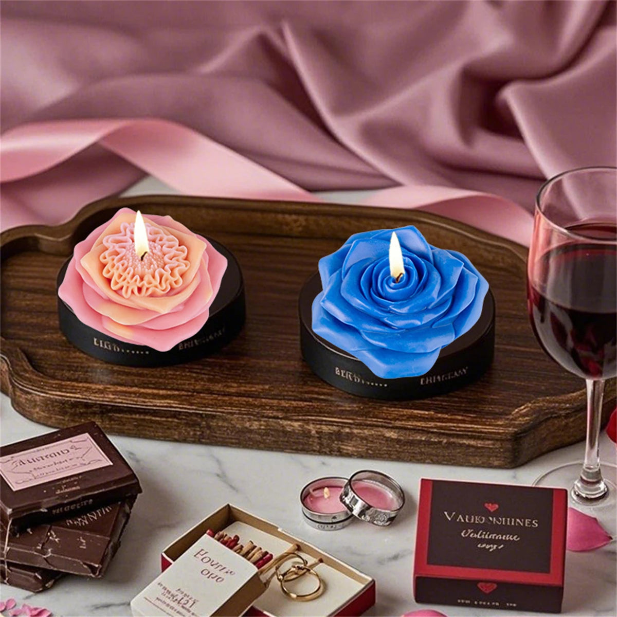 A dark wooden tray holds blue and pink floral silicone candle molds, along with jewelry and gift boxes.