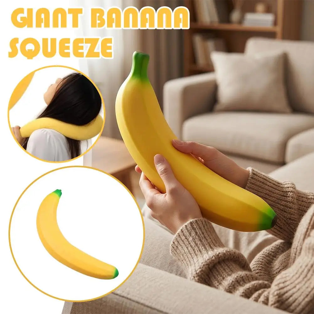 Hands squeezing a yellow giant banana squishy toy in a living room setting.