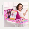 A pink kids drawing pad and art set with various colored pencils and crayons displayed on a white table.