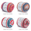 Four spools of Fairyland cake line yarn in various rainbow colors and shades for knitting and crochet