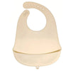 A light beige waterproof silicone baby bib with a catch pocket and multiple loops for fastening.