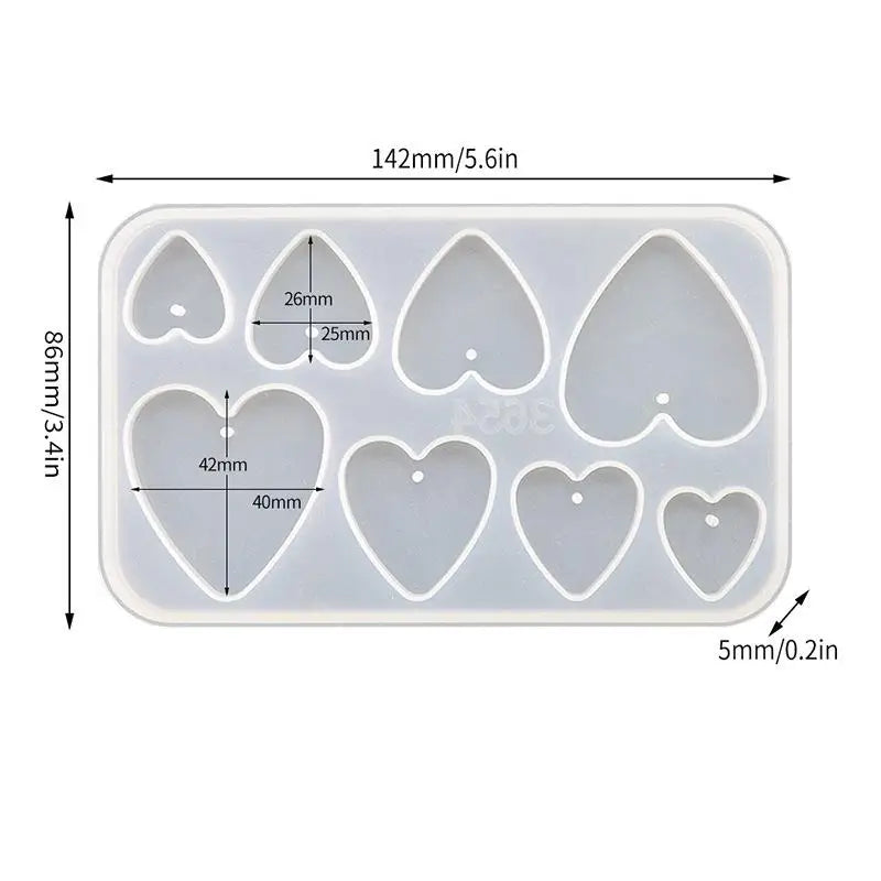 A white silicone mold set with various heart and teardrop shapes for making epoxy resin jewelry.