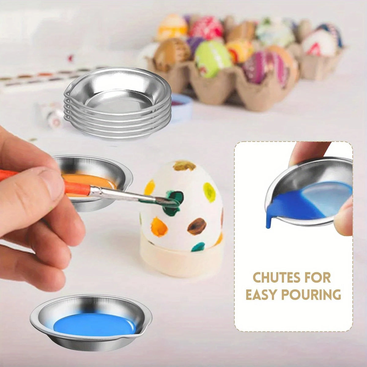 A hand is pouring blue paint from a stainless steel palette into an egg-shaped container for easy pouring.