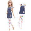 A fashion doll outfit set featuring a denim pinafore dress, striped shirt, and colorful patterned pants.